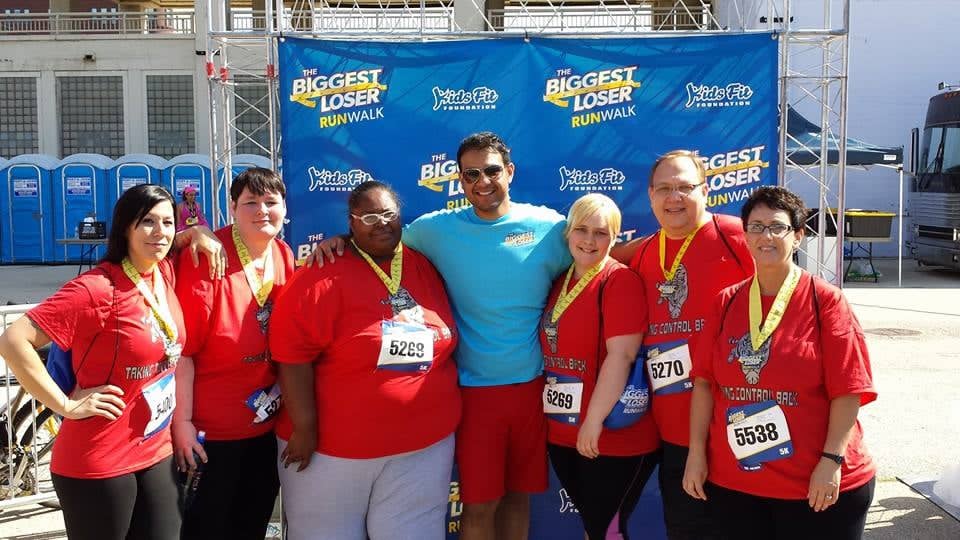 Tina at The Biggest Loser Run/Walk event with other participants and medals
