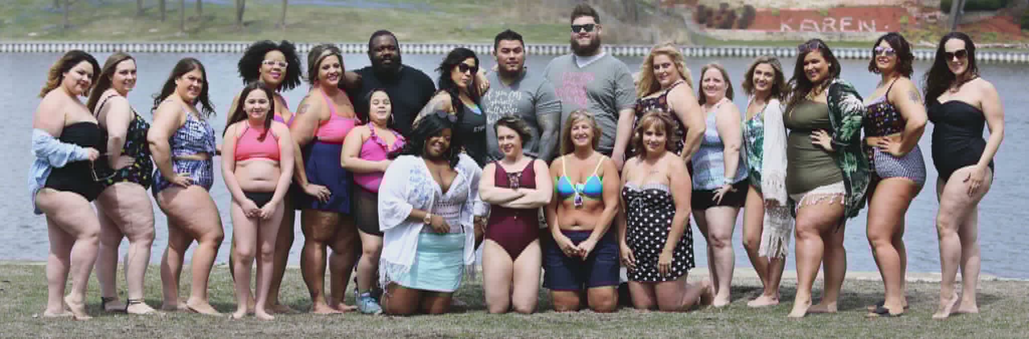 Large group of people at a body-positive lake event in swimwear