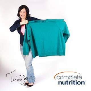 Tina as Complete Nutrition ambassador holding her old oversized clothing