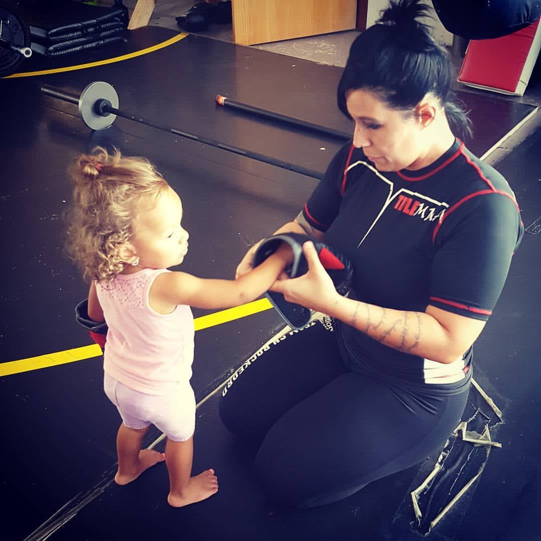 Tina doing MMA training with a child
