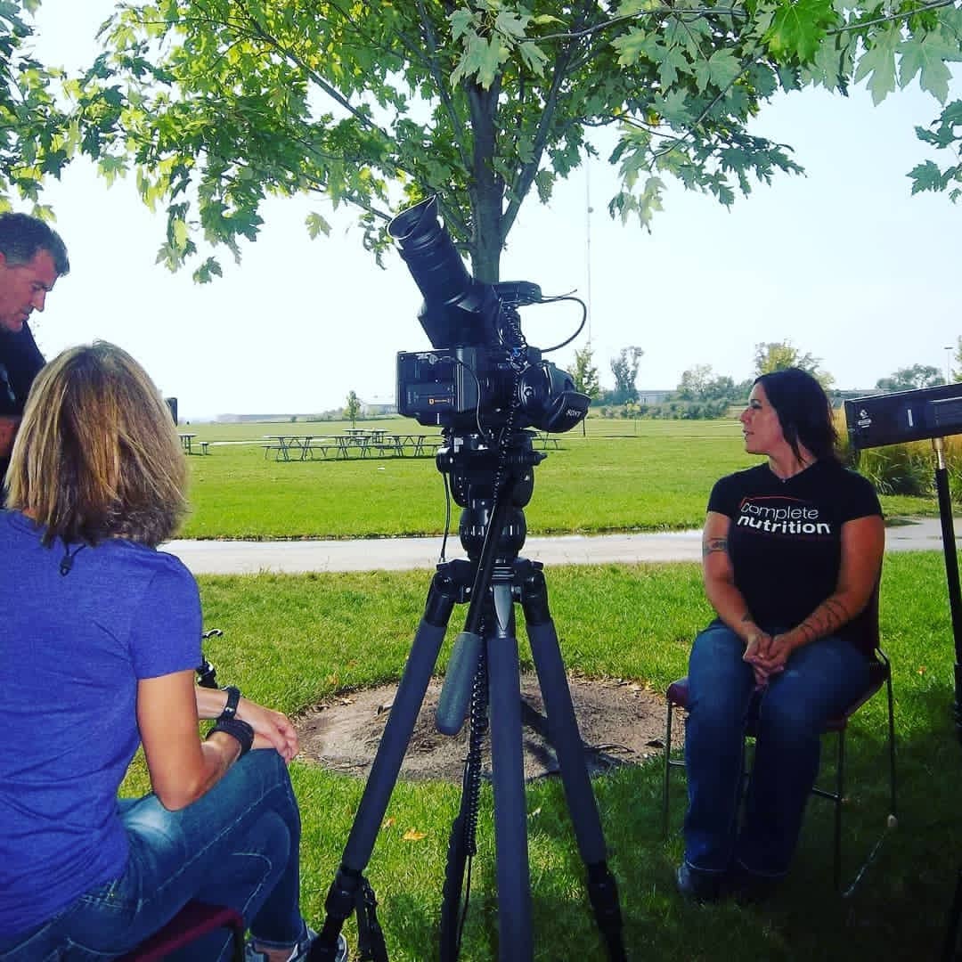 Tina being interviewed by a news crew outdoors